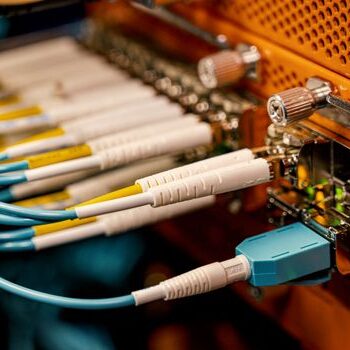 From above of optical switch equipment with many similar connectors with rubber cables and metal parts